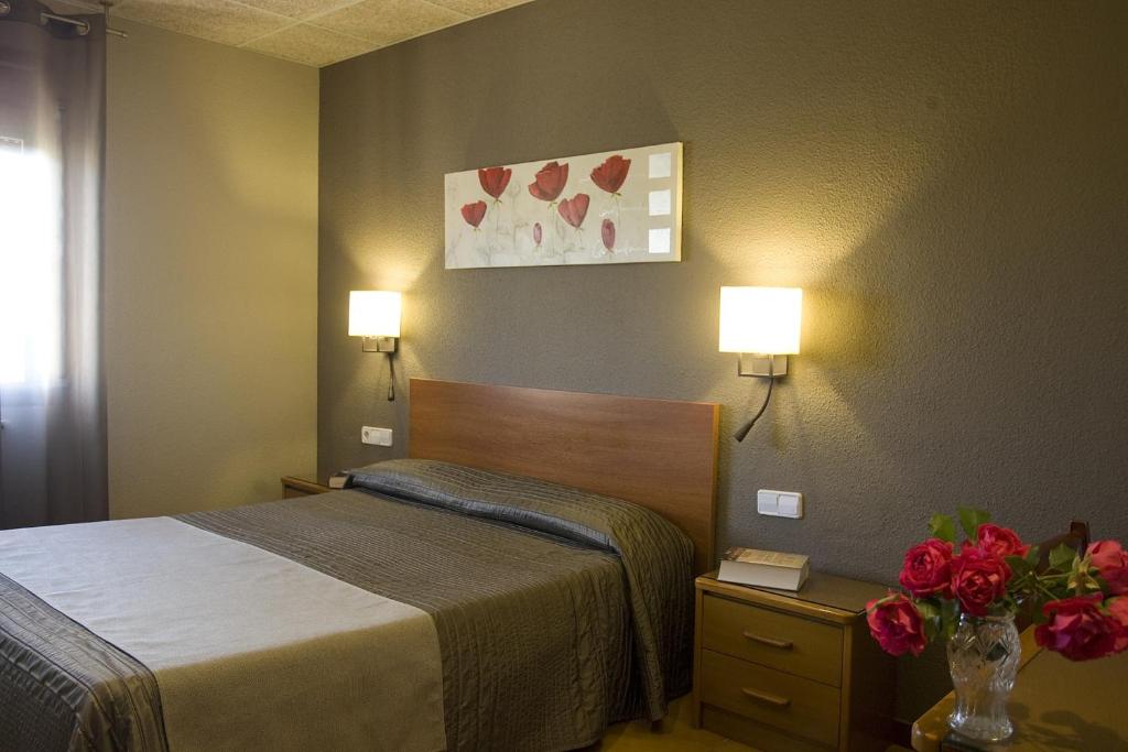 Postel nebo postele na pokoji v ubytování Hostal Barris