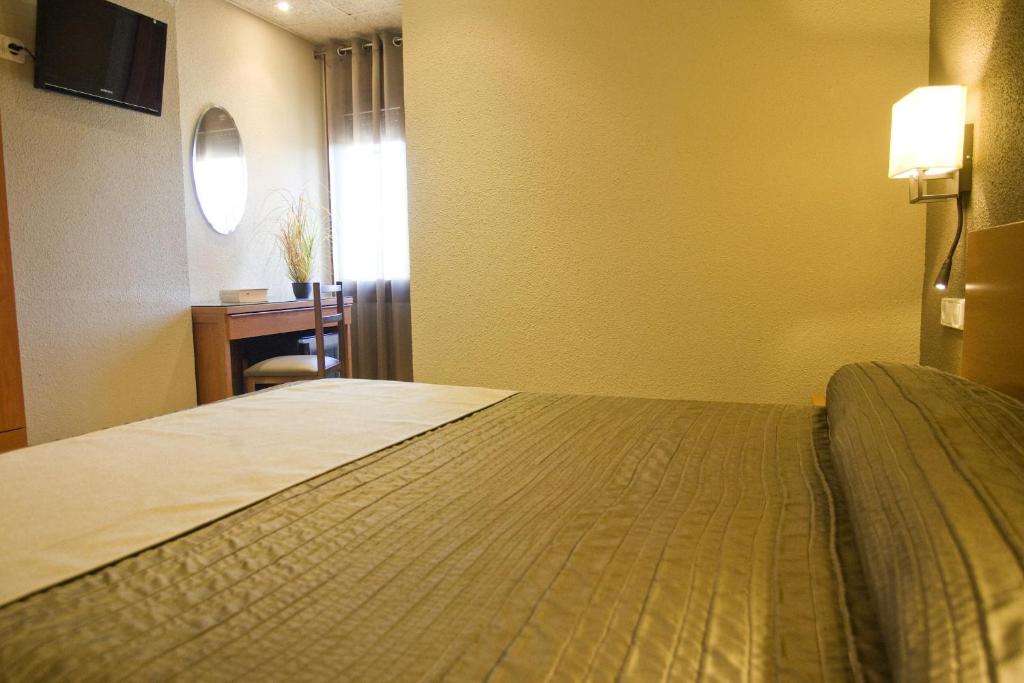 Postel nebo postele na pokoji v ubytování Hostal Barris