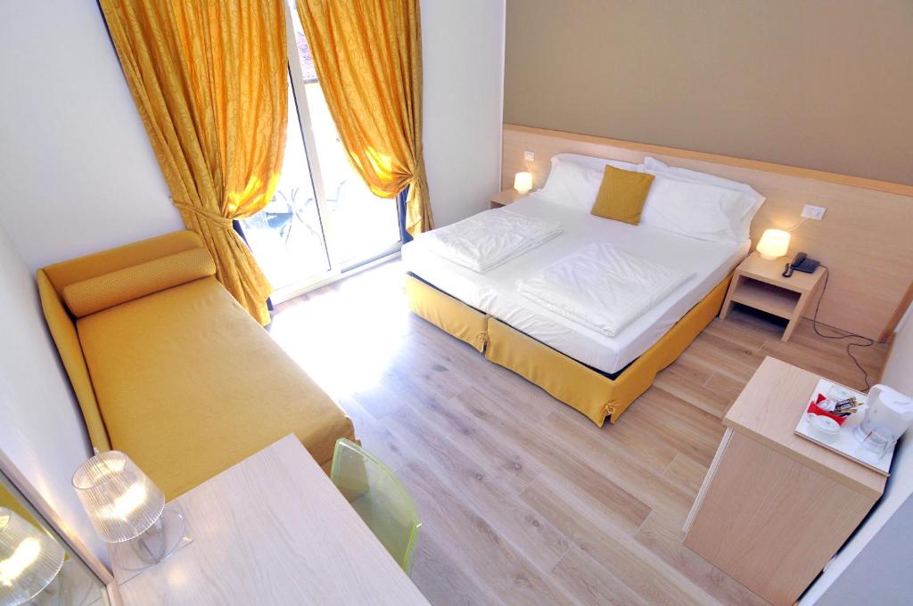 a small room with a bed and a table at Eco Hotel Cleofe in Caorle