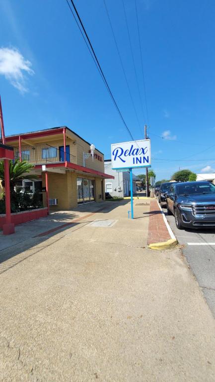 a parking inn sign in front of a parking lot at Relax Inn in Lucedale