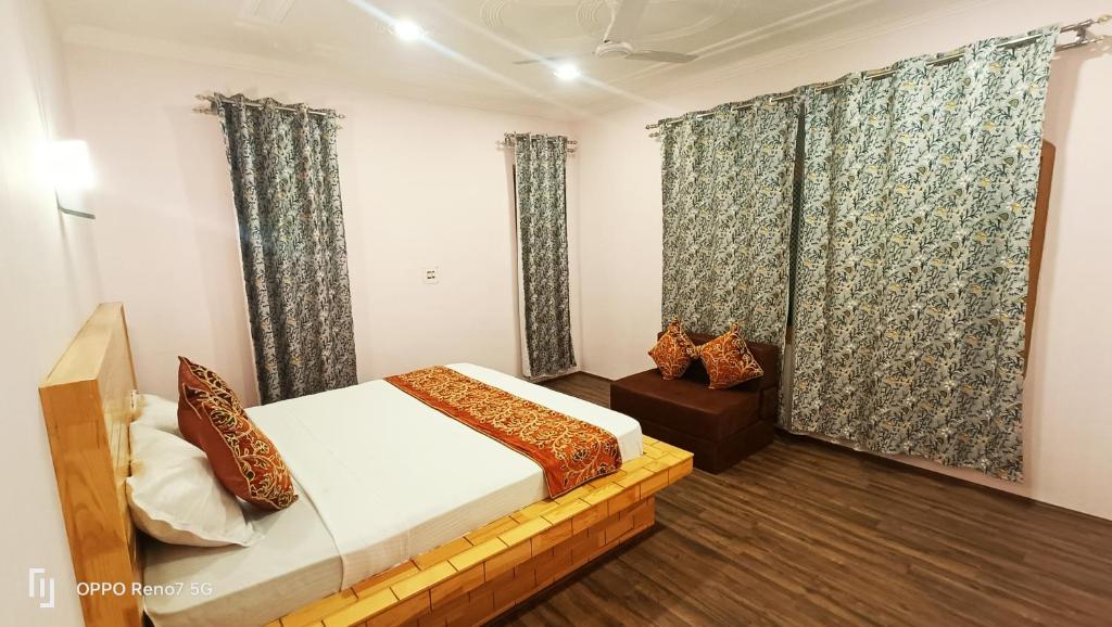 a bedroom with a bed and a window with curtains at Moonshine Home stay in Srinagar