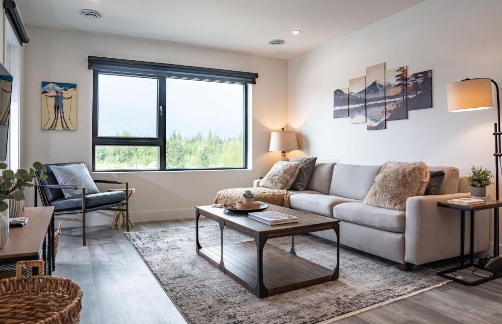 a living room with a couch and a table at Revylation by Revelstoke Vacations in Revelstoke
