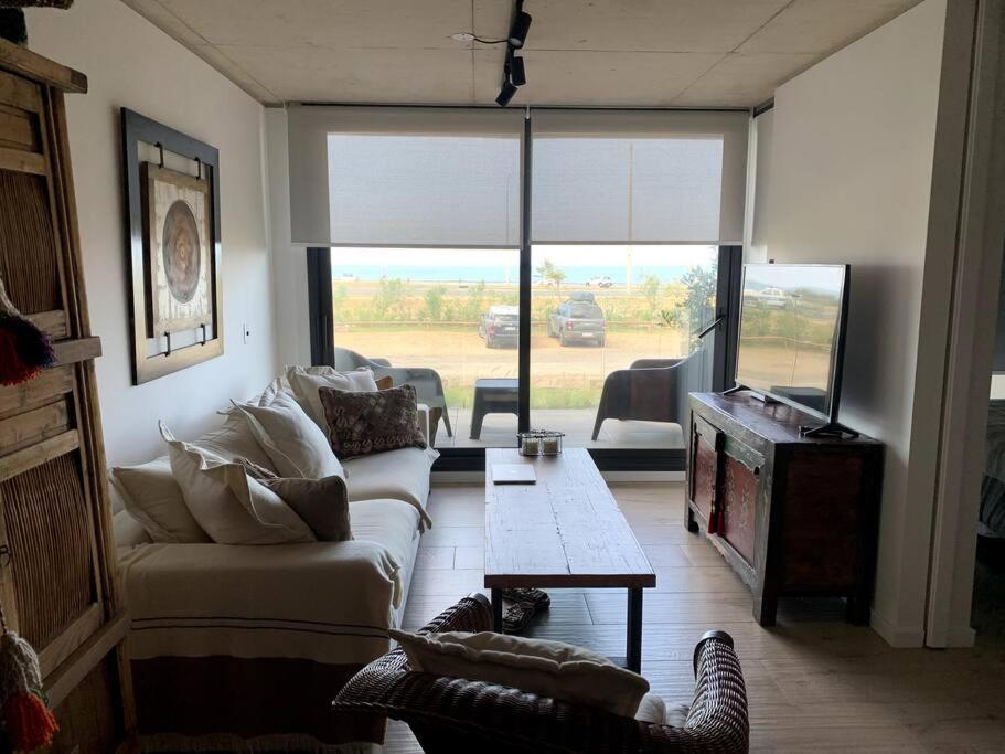 een woonkamer met een bank en een tafel bij Maravilloso Departamento al Mar in Punta del Este