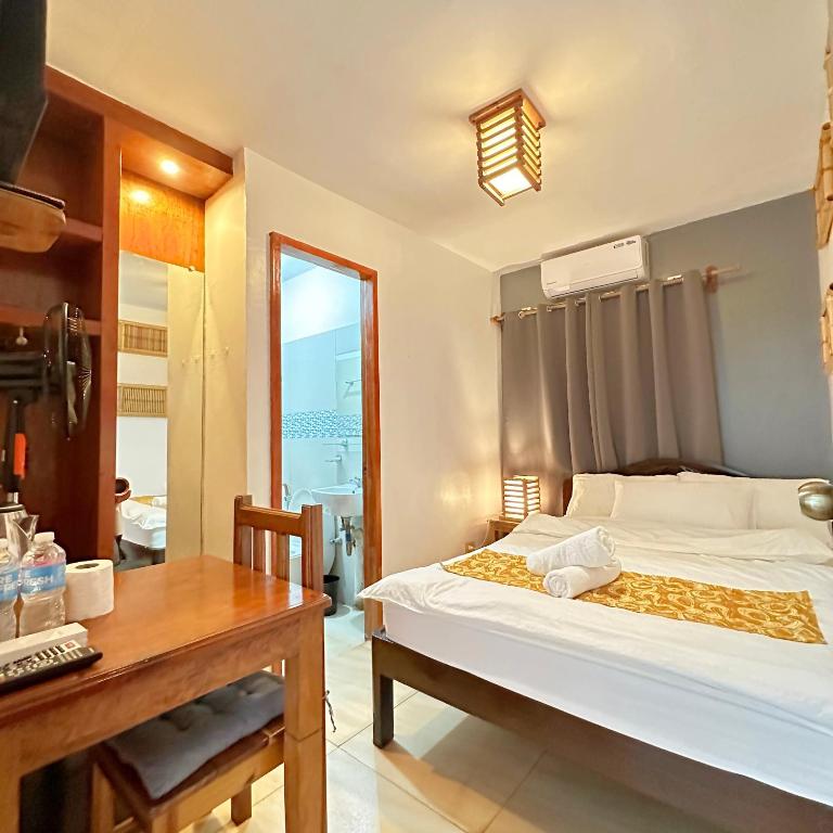 Postel nebo postele na pokoji v ubytování Earl De Princesa Hotel
