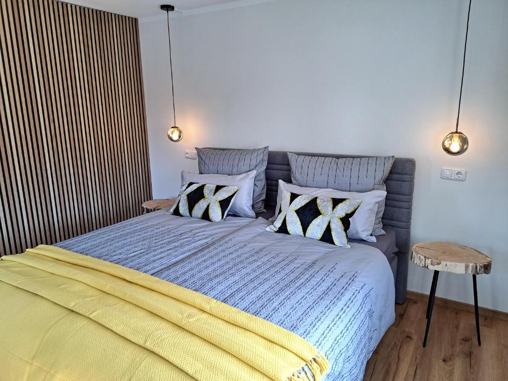 a bedroom with a bed with blue and yellow sheets at Design Apartment an der Via Claudia 