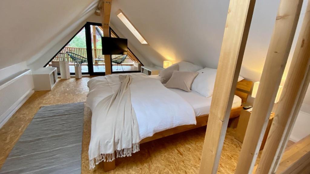 a bed with white sheets and pillows in a room at TinyLoft in Bad Teinach-Zavelstein