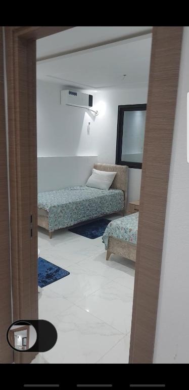 a living room with two beds and a mirror at Sweet home three bedroom house in Sousse