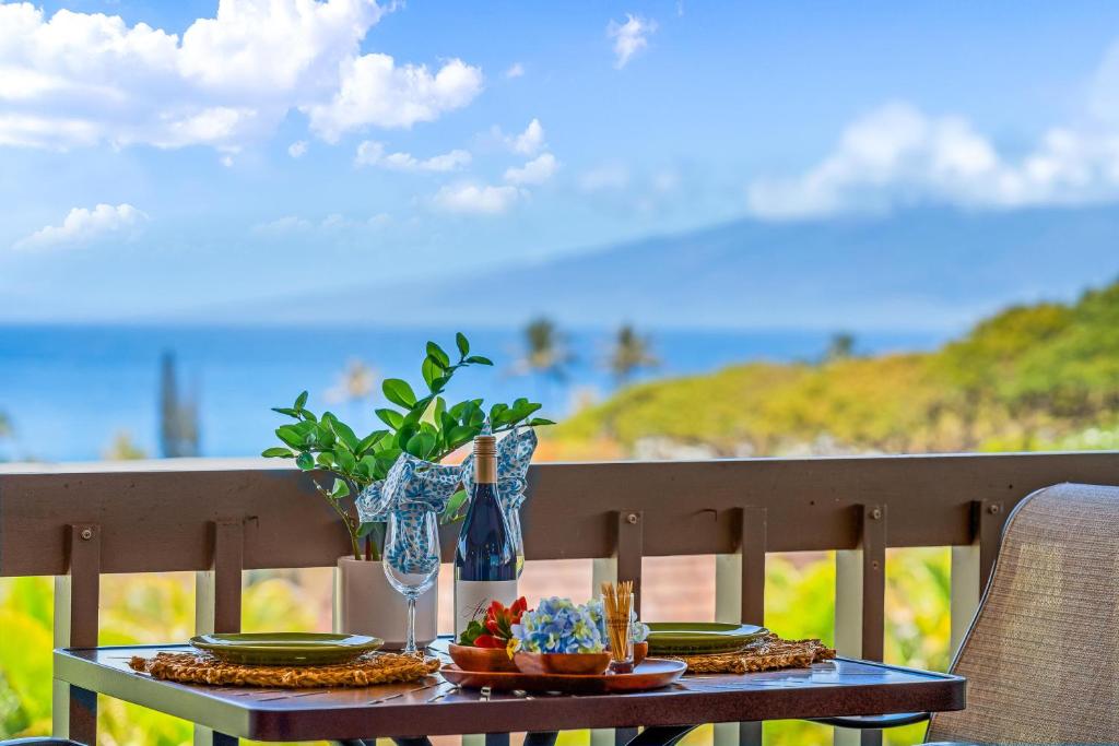 a table with a plate of food on a balcony at Kaanapali Plantation 53 in Lahaina
