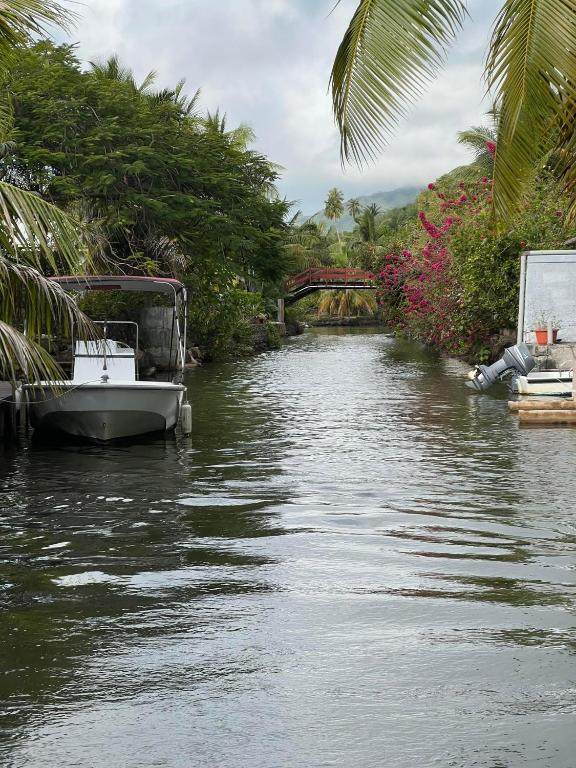 a boat is docked on a river with a bridge at chalet chenal in Hauru