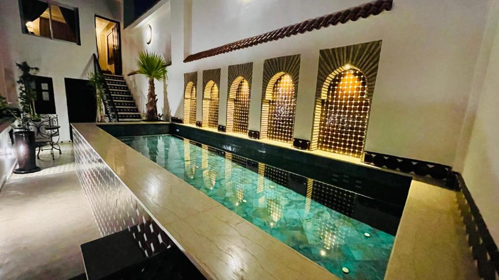 a swimming pool in the middle of a building at Dar Najat in Marrakech