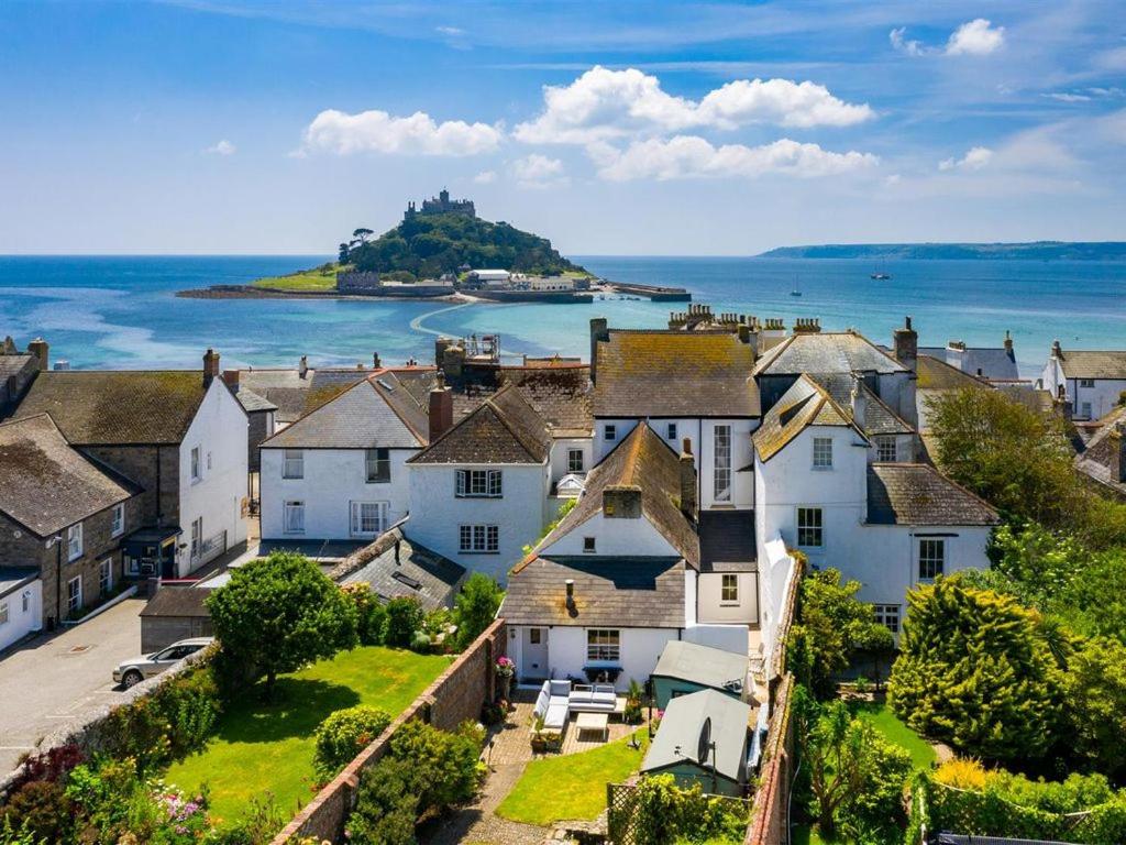 an aerial view of a town with houses and the ocean at Marazion Beach Town House with Private Parking in Marazion