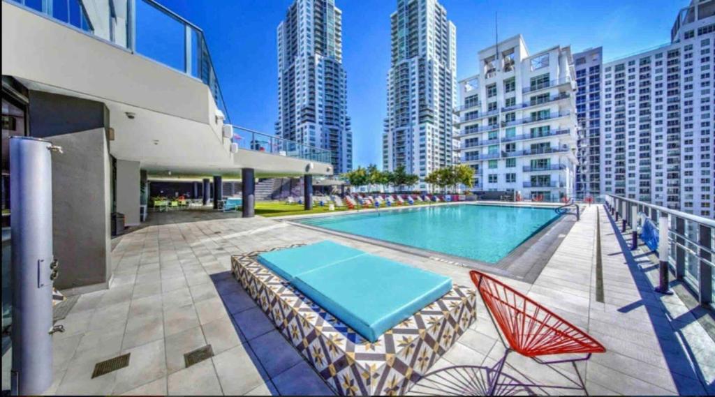 a swimming pool with two lounge chairs and a swimming poolvisor at Beautiful downtown ocean view. in Miami