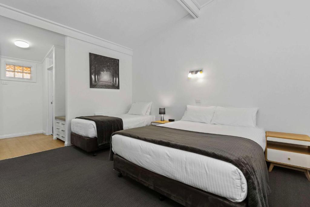 Postel nebo postele na pokoji v ubytování Econo Lodge East Adelaide