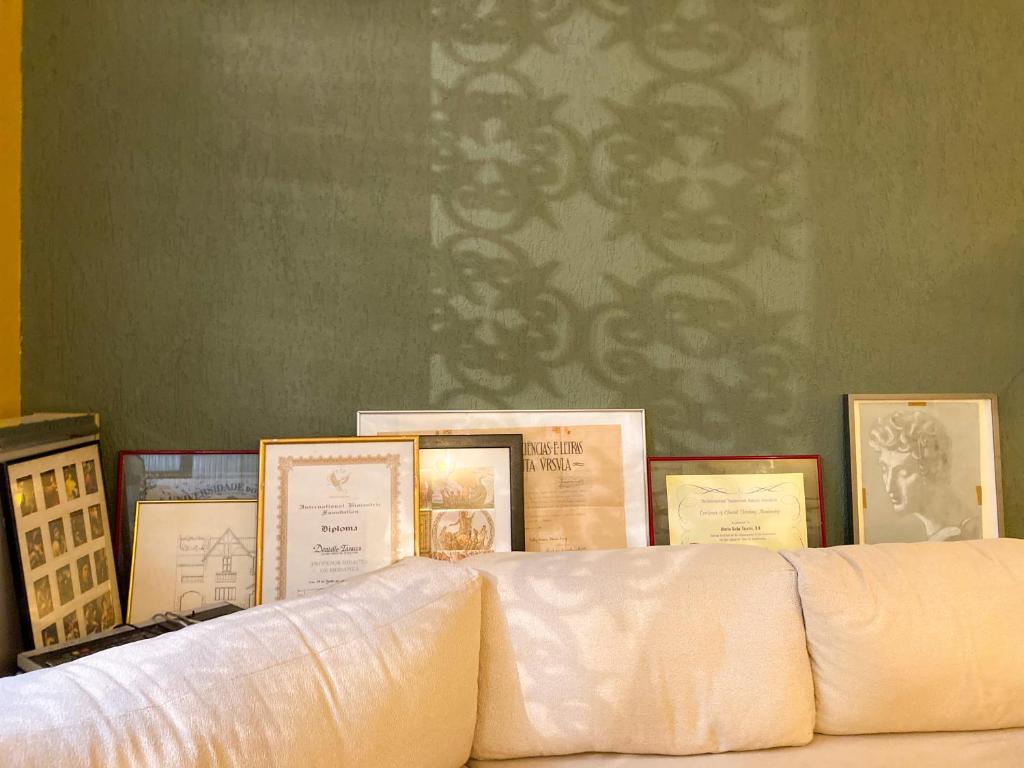 a group of framed pictures on top of a couch at Chez Zany Boutique Hostel - Copacabana in Rio de Janeiro