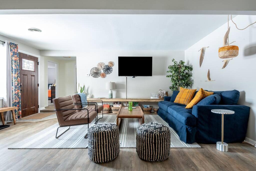 a living room with a blue couch and a tv at Blue Beach Cottage in Delavan