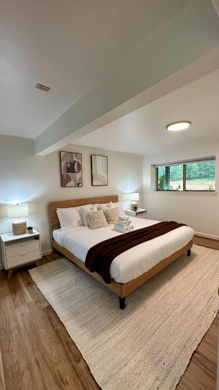 a large bedroom with a large bed and a window at New Sauk River Retreat Concrete Wa in Concrete