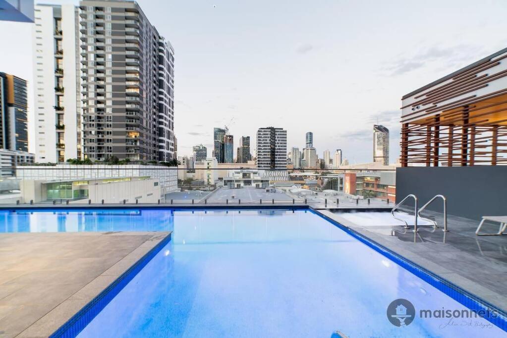 Una gran piscina con el horizonte de la ciudad al fondo en Mod Brisbane Apt near Southbank W Pool & Parking, en Brisbane