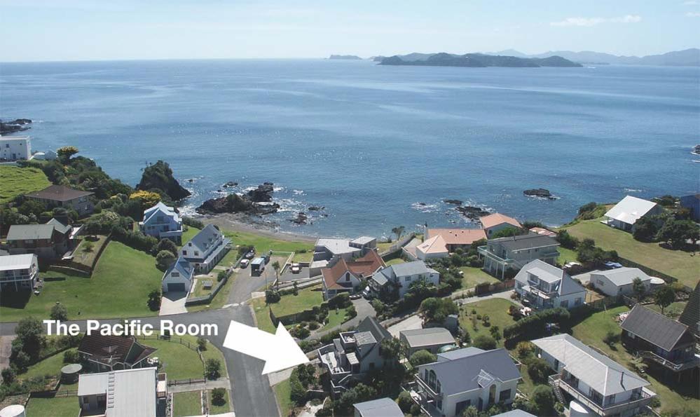 an aerial view of a residential neighborhood next to the ocean at The Pacific Room, Tapeka Point in Russell