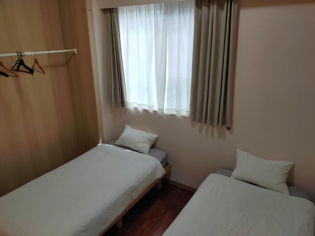 Postel nebo postele na pokoji v ubytování Horinoyado