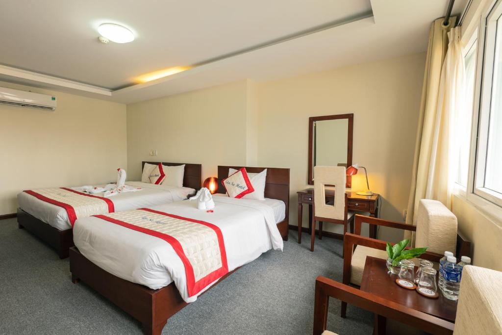 Postel nebo postele na pokoji v ubytování Tien Sa Danang Hotel