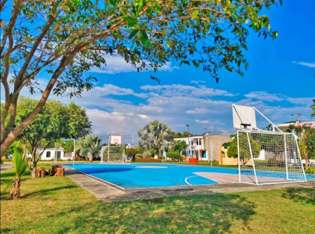 una piscina con un aro de baloncesto en un patio en Casa Flandes, en Flandes