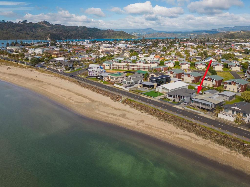 an aerial view of a beach and a city at Beside the sea, park up and relax - Just 20 steps to the beach - Wi-Fi & Linen in Whitianga