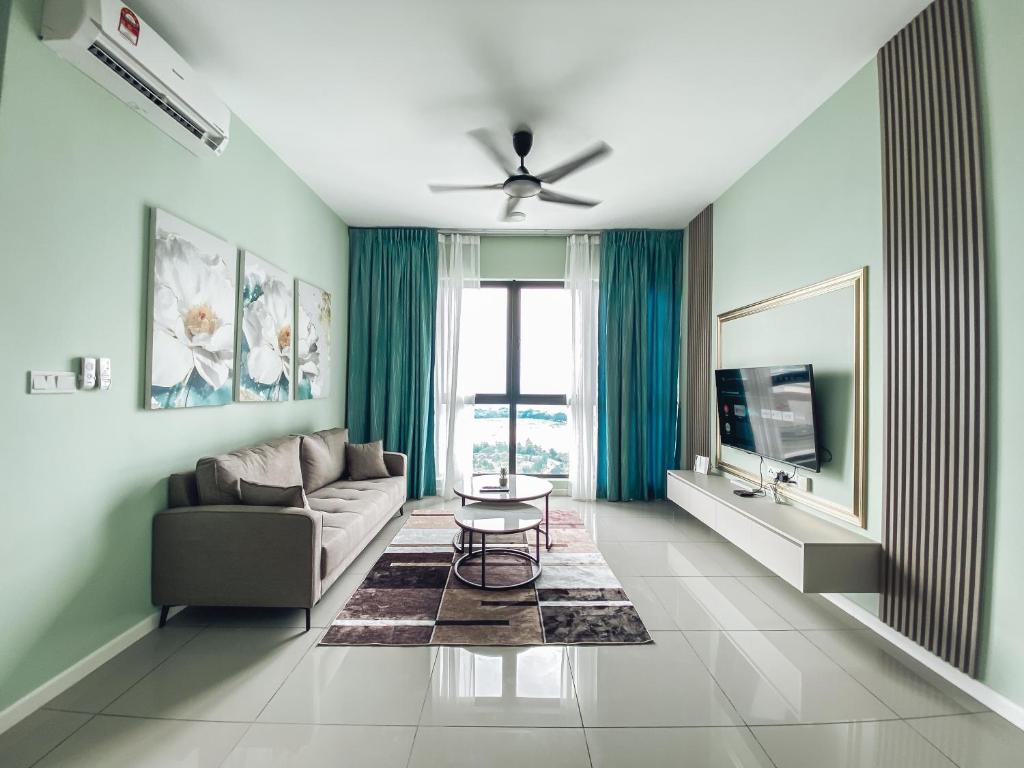 a living room with a couch and a table at Family-Friendly 3-Bedroom Condo at IOI Resort City in Kampong Abu Bakar
