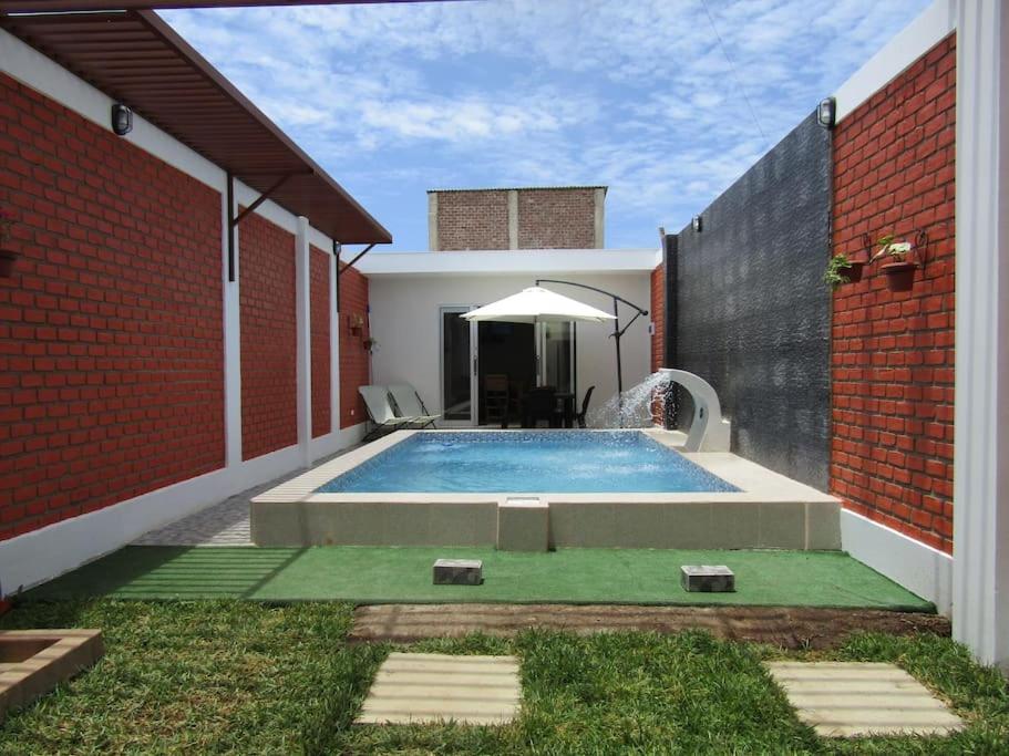 a swimming pool in the backyard of a house at Casa de Playa en Colan Casa Merino. in Paita