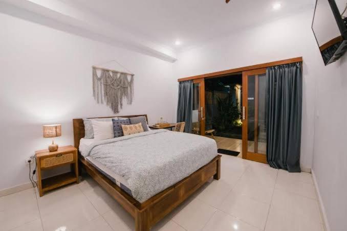 a bedroom with a bed and a large window at siadiw GuestHouse in Cikaroya