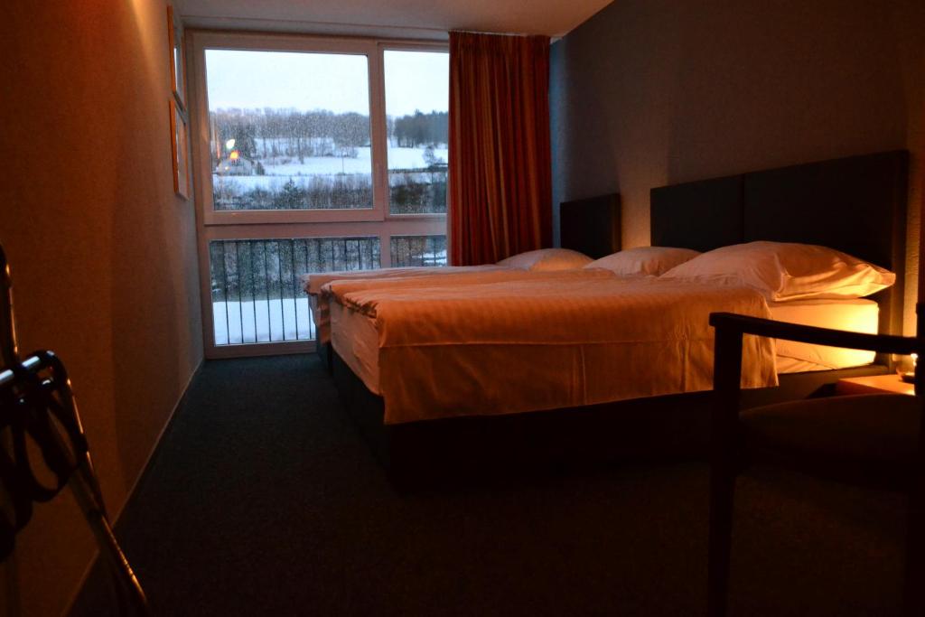 Postel nebo postele na pokoji v ubytování Hotel Les Rives Du Doubs