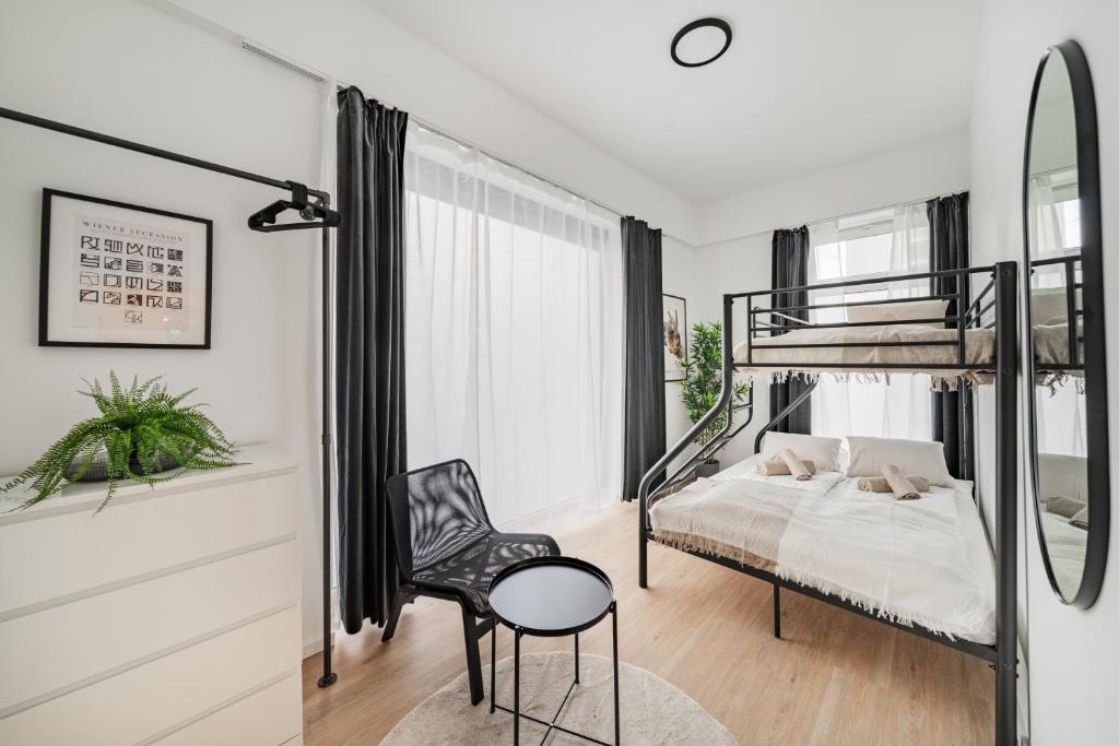 sypialnia z łóżkiem piętrowym i krzesłem w obiekcie Chic Central City Rooms by Home2 w Wiedniu