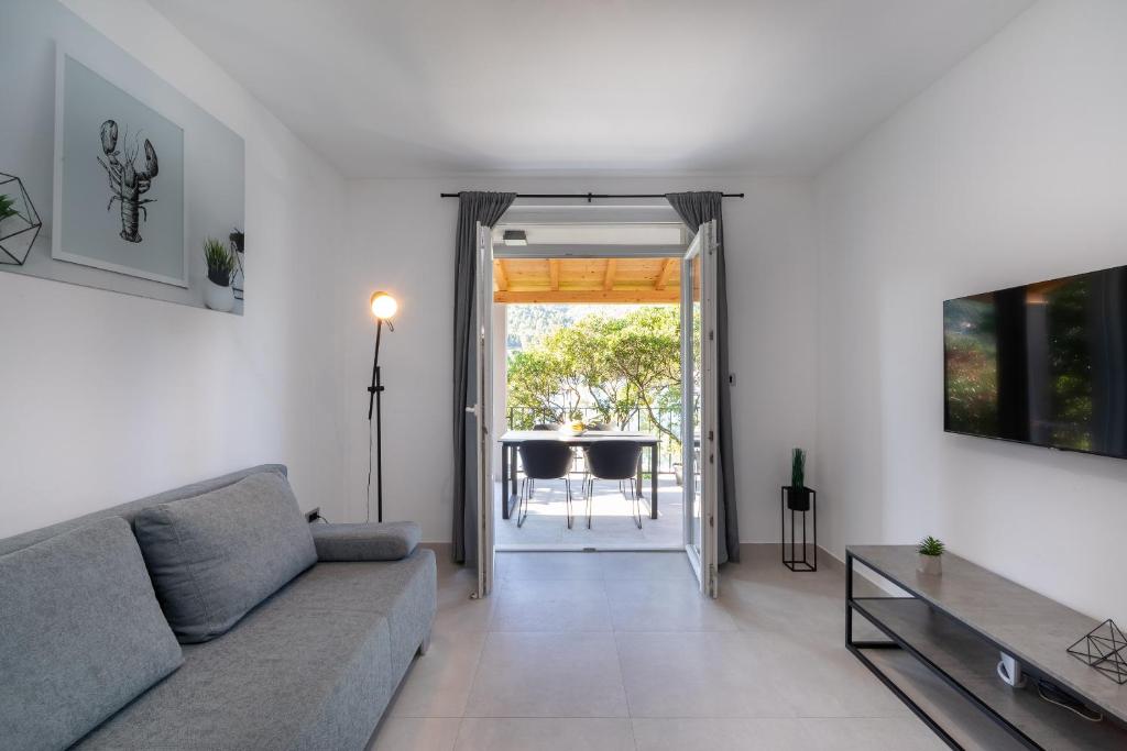 a living room with a couch and a table at The Plaza Ground Floor Apartments in Prizba