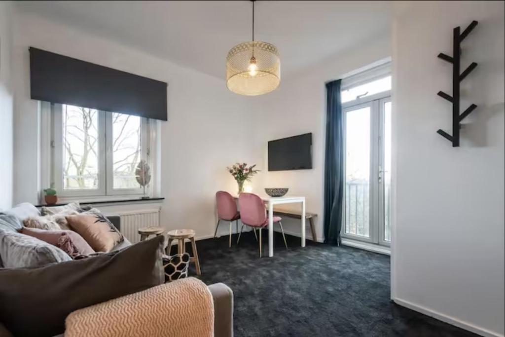 a living room with a couch and a table at Cozy 2-bedroom apartment in Amsterdam