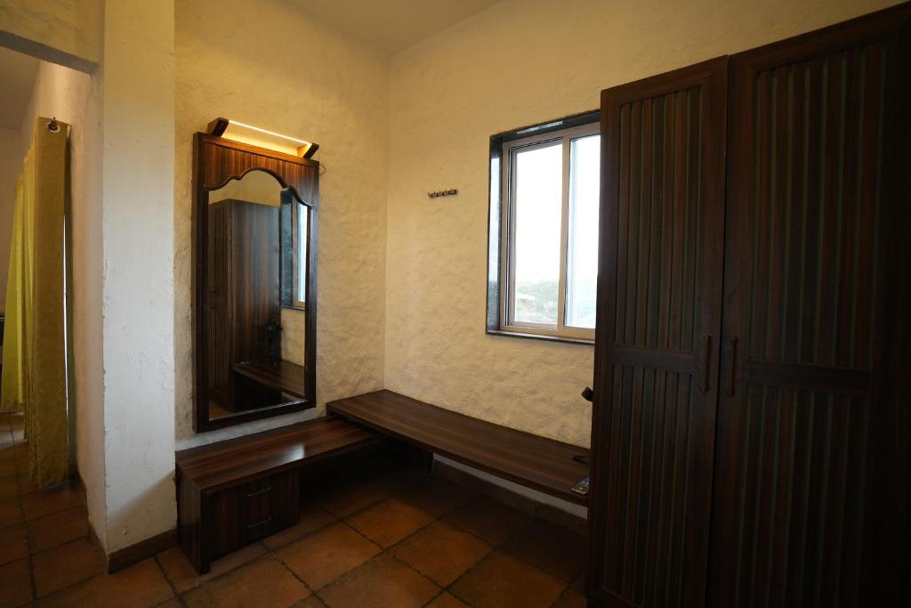 a bathroom with a window and a wooden bench at Waterstone resort 