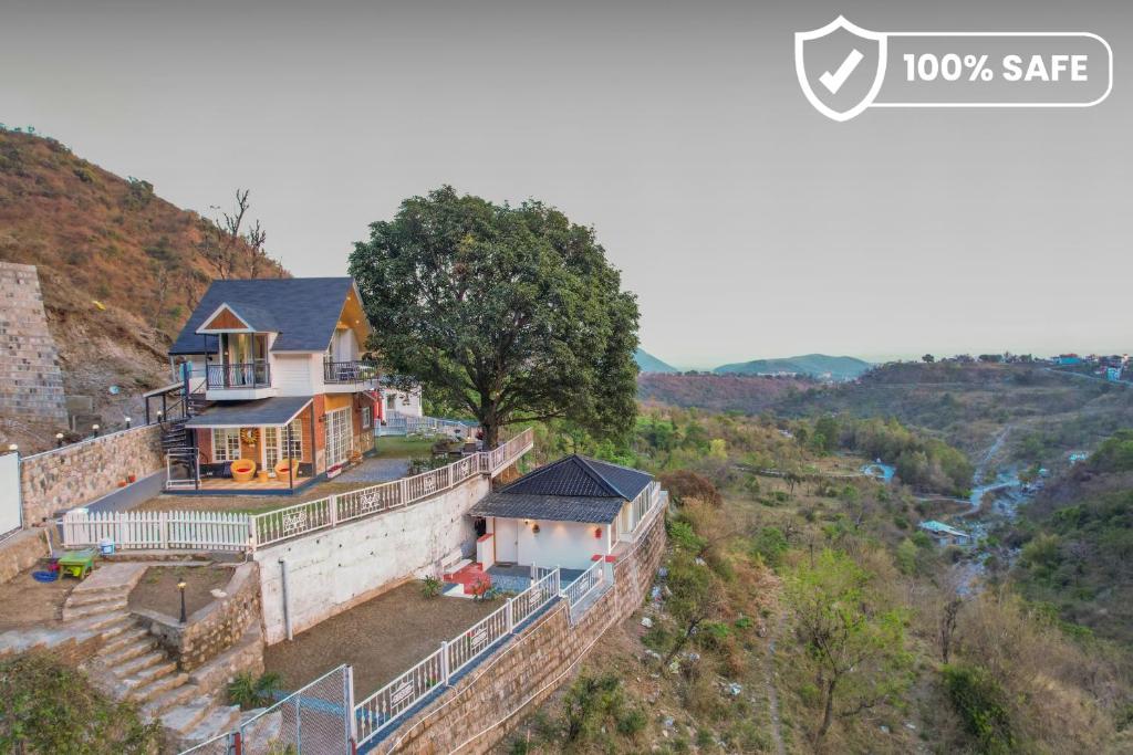 an aerial view of a house on top of a wall at SaffronStays Woodpeckers Villa, Dehradun in Rājpur