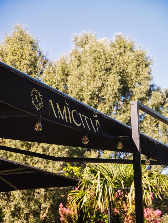 a black bench with the word nirvana on it at Amicitia - Hôtel &amp; Restaurant in LʼIsle-Adam