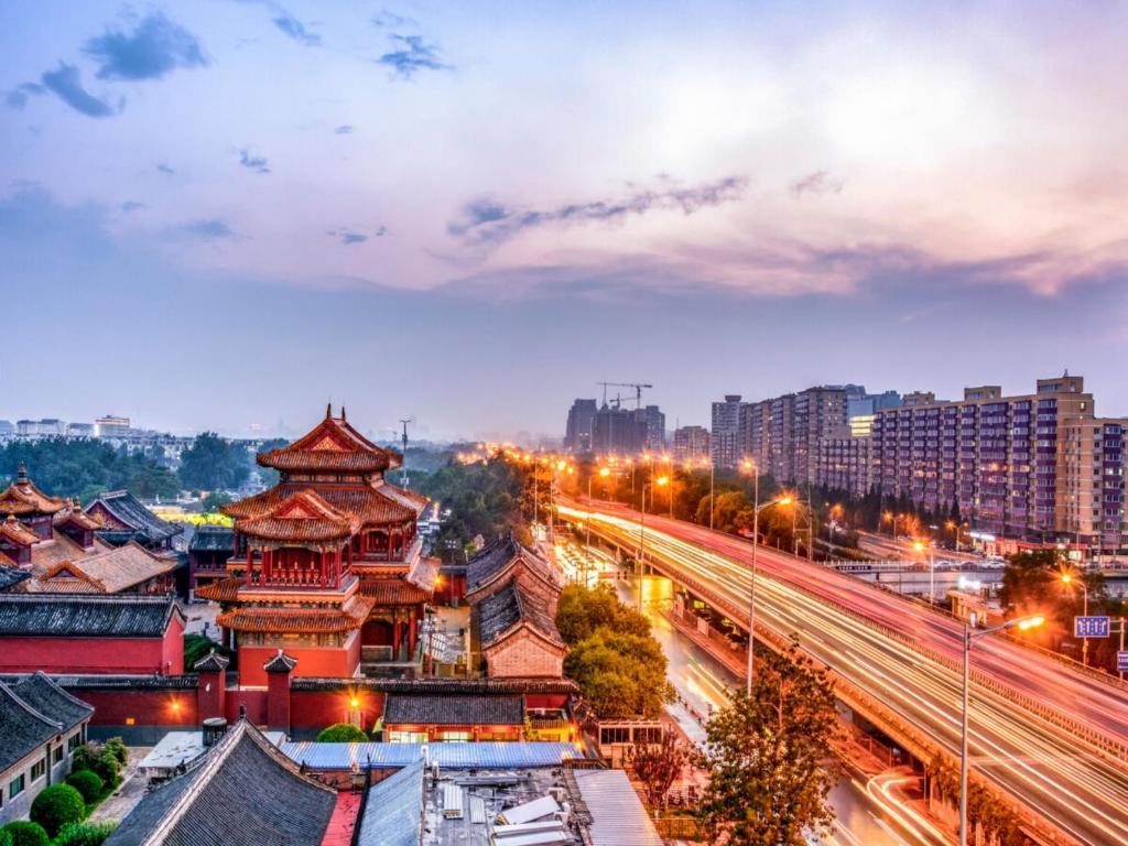 a cityscape of a city at night with traffic w obiekcie Happy Dragon Alley Hotel-In the city center with big window&free coffe, Fluent English speaking,Tourist attractions ticket service&food recommendation,Near Tian Anmen Forbiddencity,Near Lama temple,Easy to walk to NanluoAlley&Shichahai w Pekinie