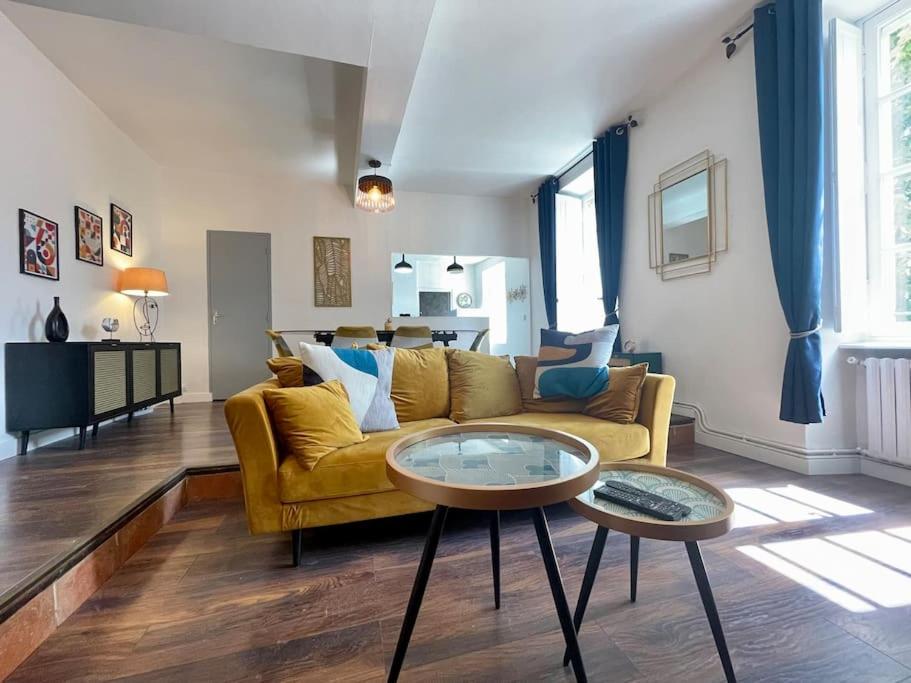 ein Wohnzimmer mit einem gelben Sofa und einem Tisch in der Unterkunft Charleston chic ※ centre-ville in Carcassonne
