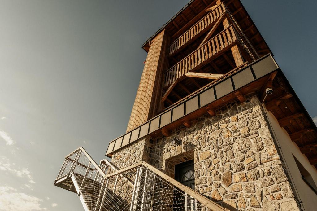 a building with a staircase on the side of it at Gostilnica Orle - Sleeping in the tower in Škofljica