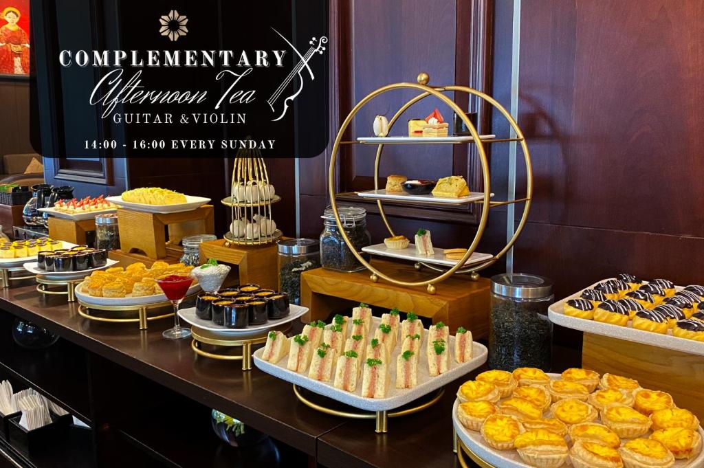 a buffet with various pastries and desserts on display at Nhat Ha L’Opera Hotel in Ho Chi Minh City