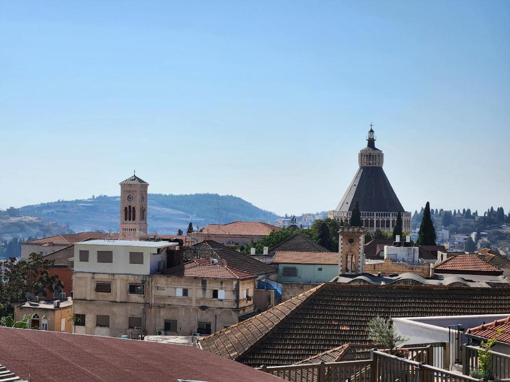a view of a city with roofs and buildings at Daher Guest House Nazareth in Nazareth