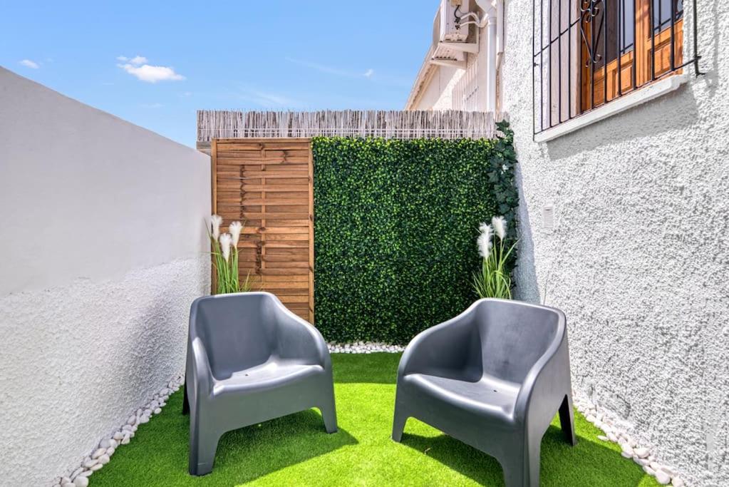 dwa krzesła siedzące na trawie obok budynku w obiekcie Luxe apartment, Chill Out, Beach 10 min w Alicante