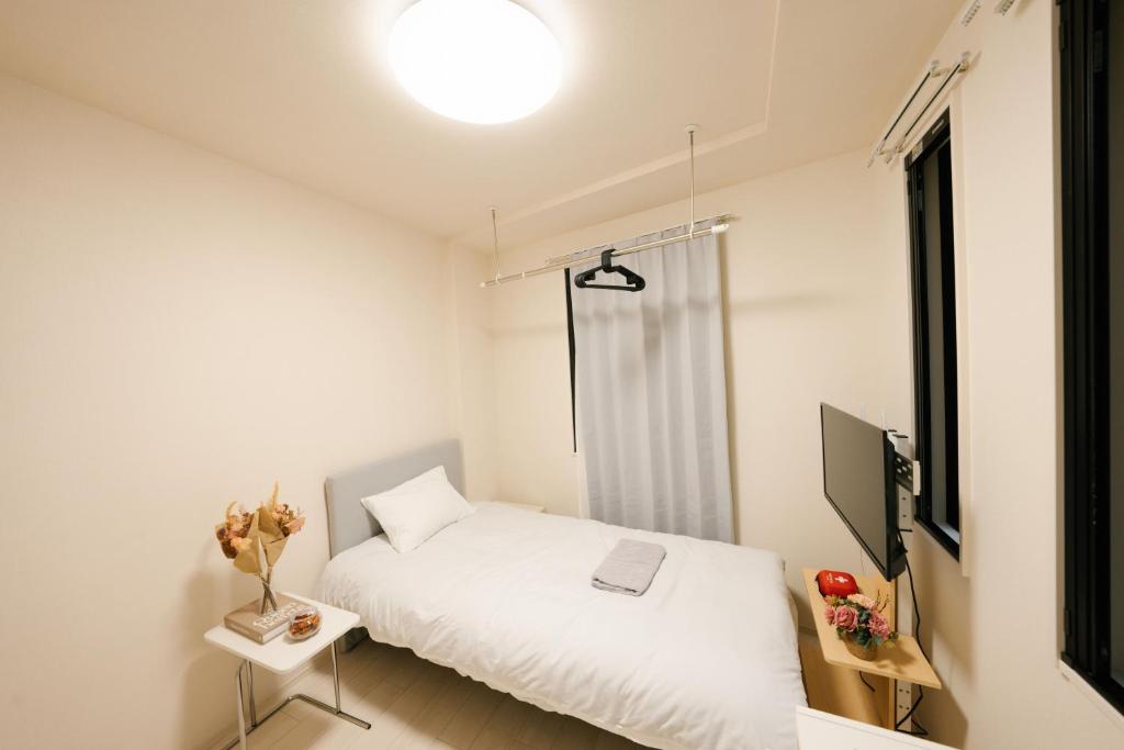 Postel nebo postele na pokoji v ubytování FL Residence Shinjuku II