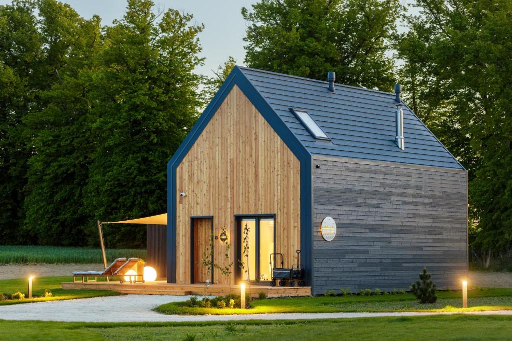 une petite maison avec un toit bleu dans l'établissement Przylądek Marzeń - Domy nad morzem, à Ustronie Morskie