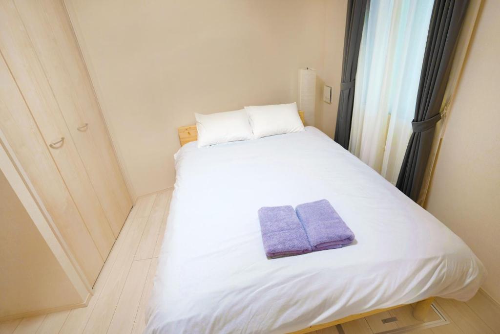 Postel nebo postele na pokoji v ubytování FL Residence Shinjuku II