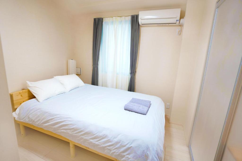 Postel nebo postele na pokoji v ubytování FL Residence Shinjuku II