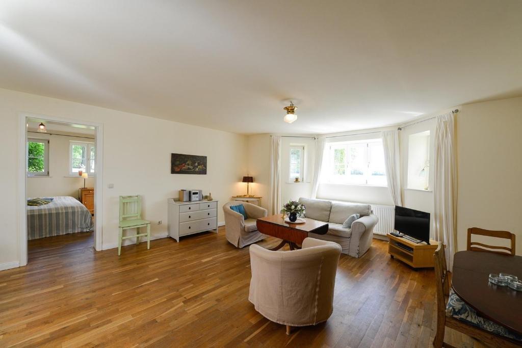 a living room with a couch and a table at Ferienwohnung 1 mit schönem Seeblick in Neuenkirchen