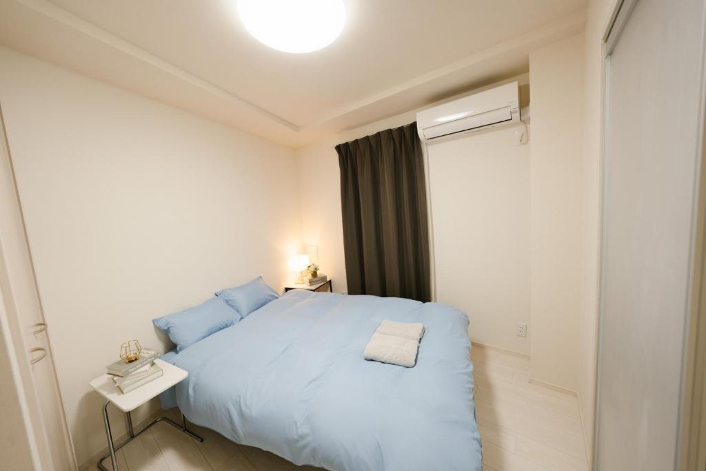 Postel nebo postele na pokoji v ubytování FL Residence Shinjuku II