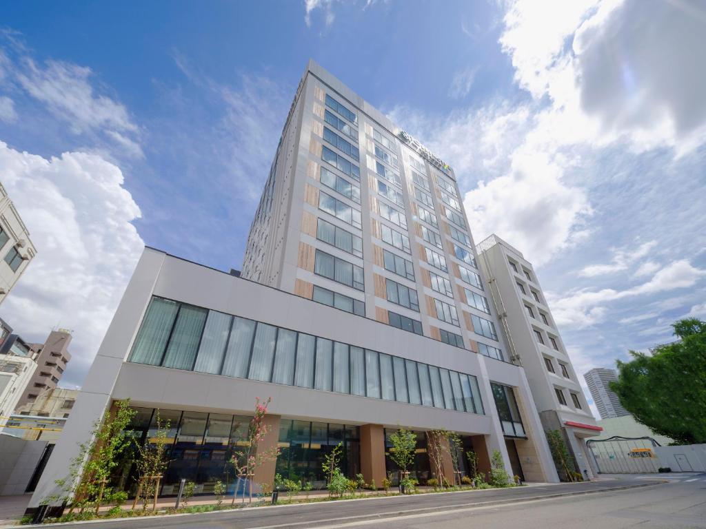 a tall white building on a city street at Tosei Hotel Cocone Tsukiji Ginza Premier in Tokyo