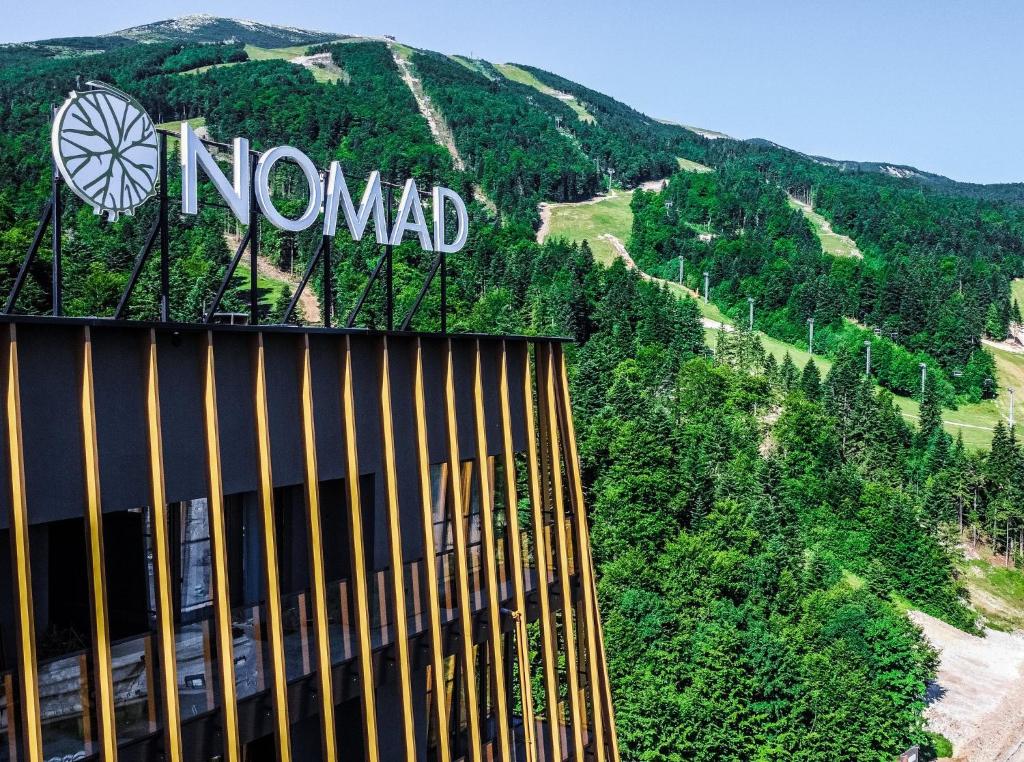 a sign that reads nomad on top of a mountain at Hotel Nomad in Bjelašnica